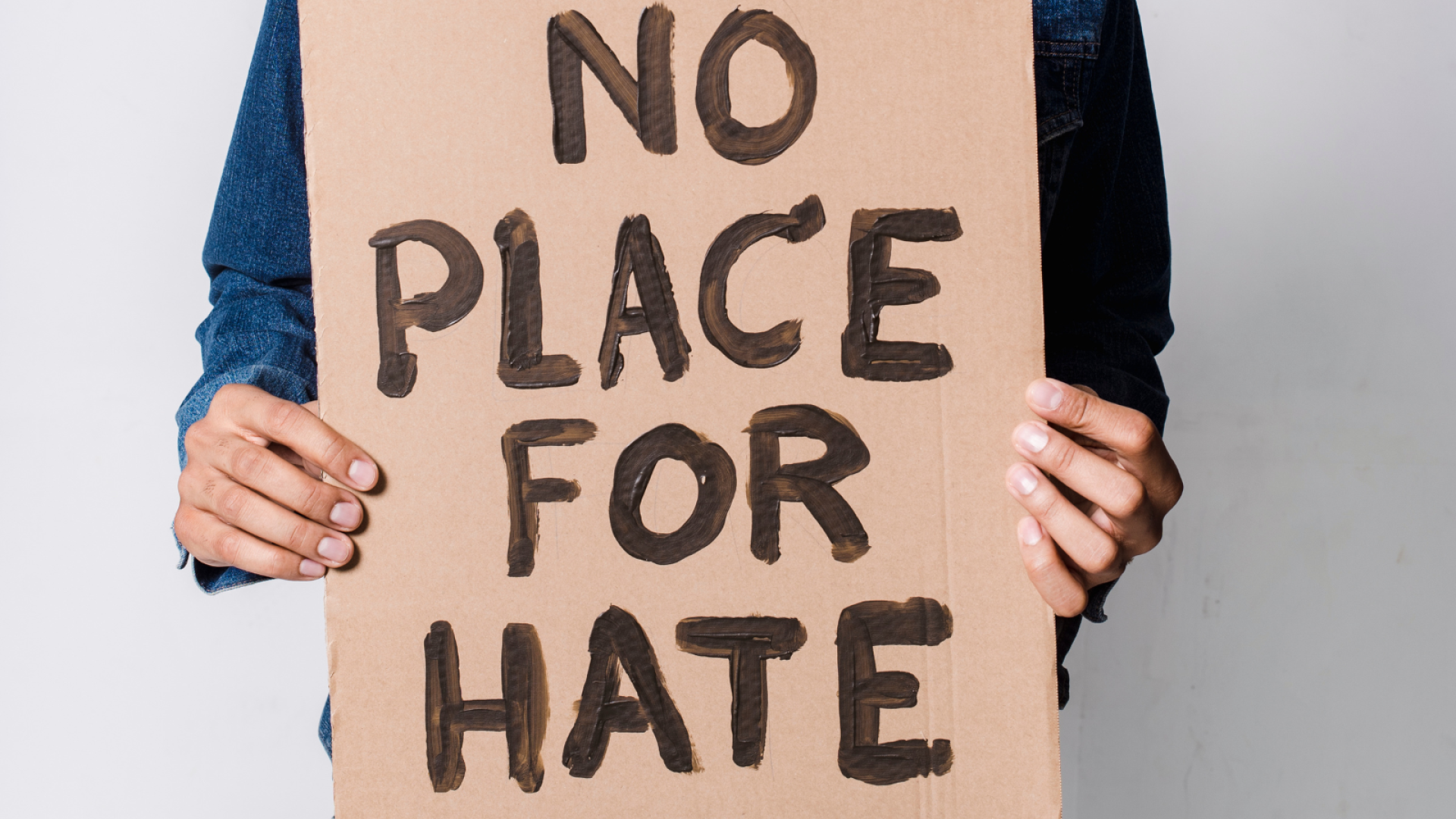 Text reads no place for hate on a placard